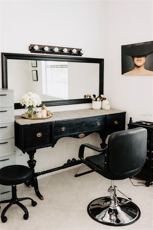 A vanity area features a black desk, a large mirror, and a salon-style chair — 1873 E ISLES ROAD, PORT CHARLOTTE, FL