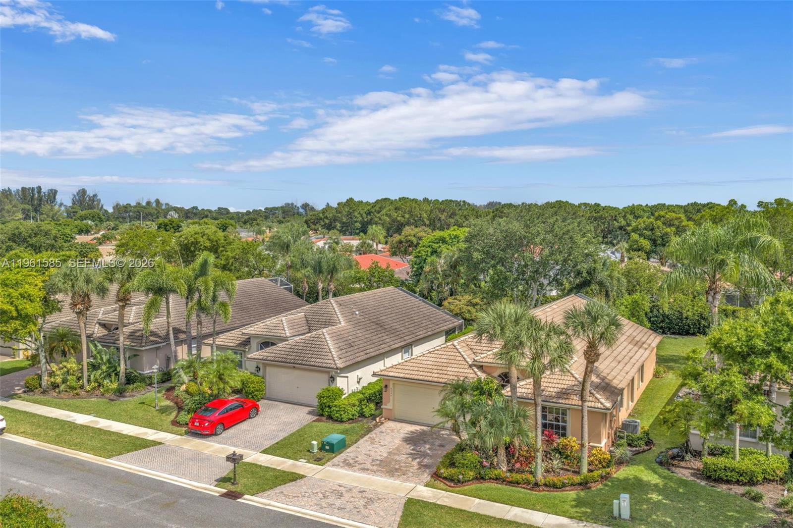 An aerial view shows two single-story suburban houses with tiled roofs and paved driveways — 8046 Duomo Cir, Boynton Beach FL 33472, BOYNTON BEACH, FL