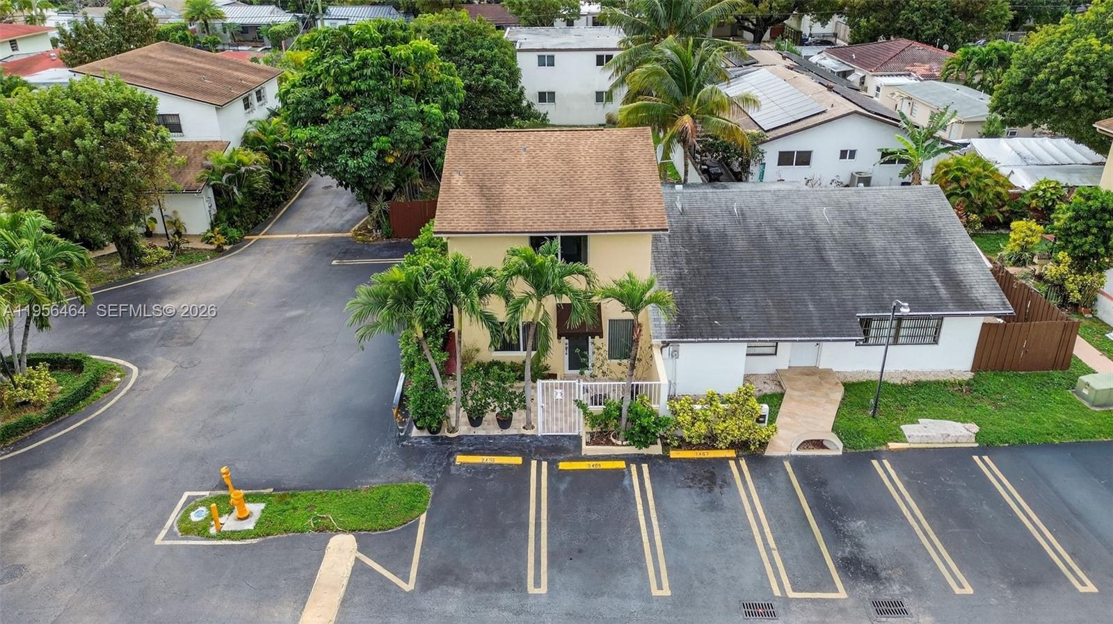 An aerial view shows a two-story building with a parking lot and palm trees — 2455 SW 11th St # A, Miami FL 33135, MIAMI, FL