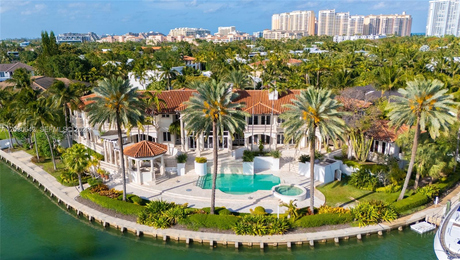 An aerial view of a waterfront mansion with a pool, gazebo, and palm trees — 260 Cape Florida Dr, Key Biscayne FL 33149, KEY BISCAYNE, FL