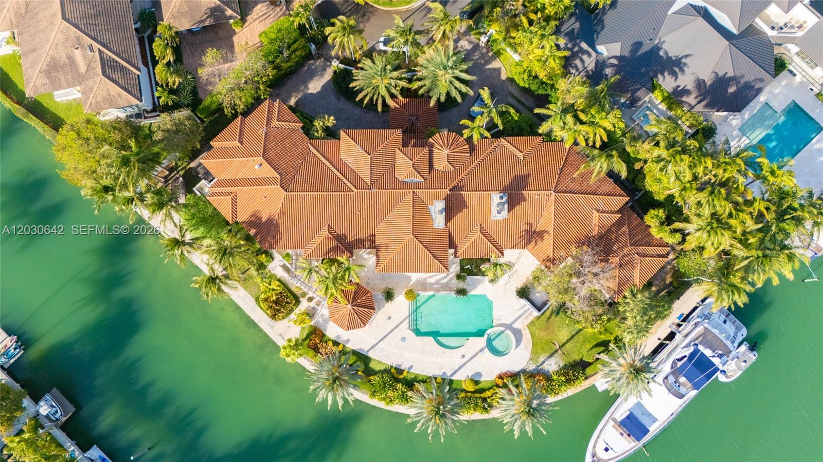 An aerial view shows a large waterfront house with a tiled roof and swimming pool — 260 Cape Florida Dr, Key Biscayne FL 33149, KEY BISCAYNE, FL