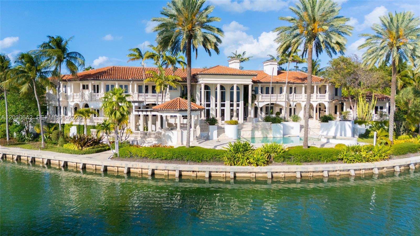 A large waterfront mansion with a tiled roof, white columns, and a swimming pool — 260 Cape Florida Dr, Key Biscayne FL 33149, KEY BISCAYNE, FL