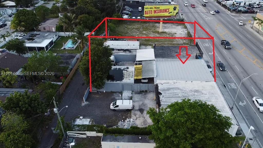 An aerial view shows a commercial property with a building and a vacant lot — 10342 NW 27th Ave, Miami FL 33147, MIAMI, FL