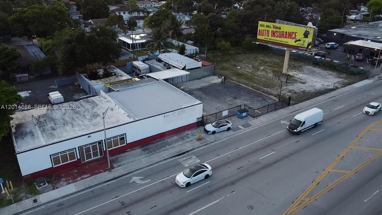 An aerial view shows a commercial building with a parking lot and a billboard — 10342 NW 27th Ave, Miami FL 33147, MIAMI, FL