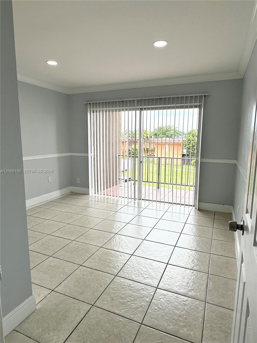 A room with light gray walls, tile flooring, and a sliding glass door to a balcony — 9405 SW 76th St # Y32, Miami FL 33173, MIAMI, FL
