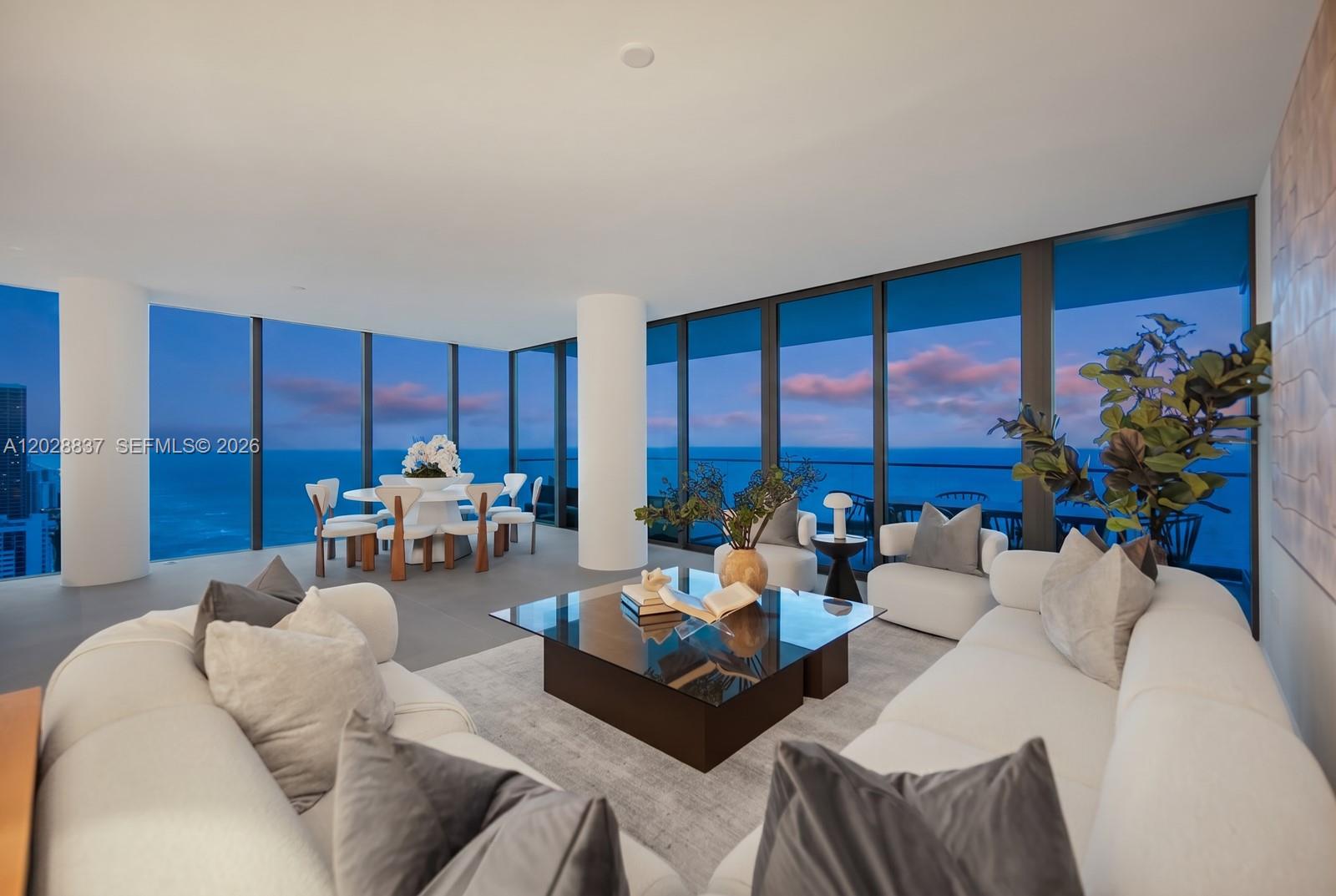 A modern living and dining area features floor-to-ceiling windows with panoramic ocean views — 2000 S Ocean Dr # 32A, Hallandale Beach FL 33009, HALLANDALE BEACH, FL