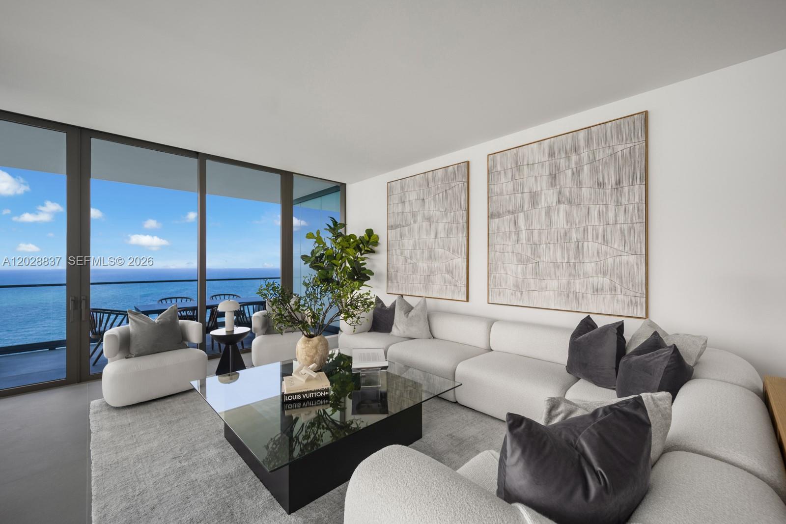 A modern living room features a white sectional sofa, glass coffee table, and ocean views — 2000 S Ocean Dr # 32A, Hallandale Beach FL 33009, HALLANDALE BEACH, FL