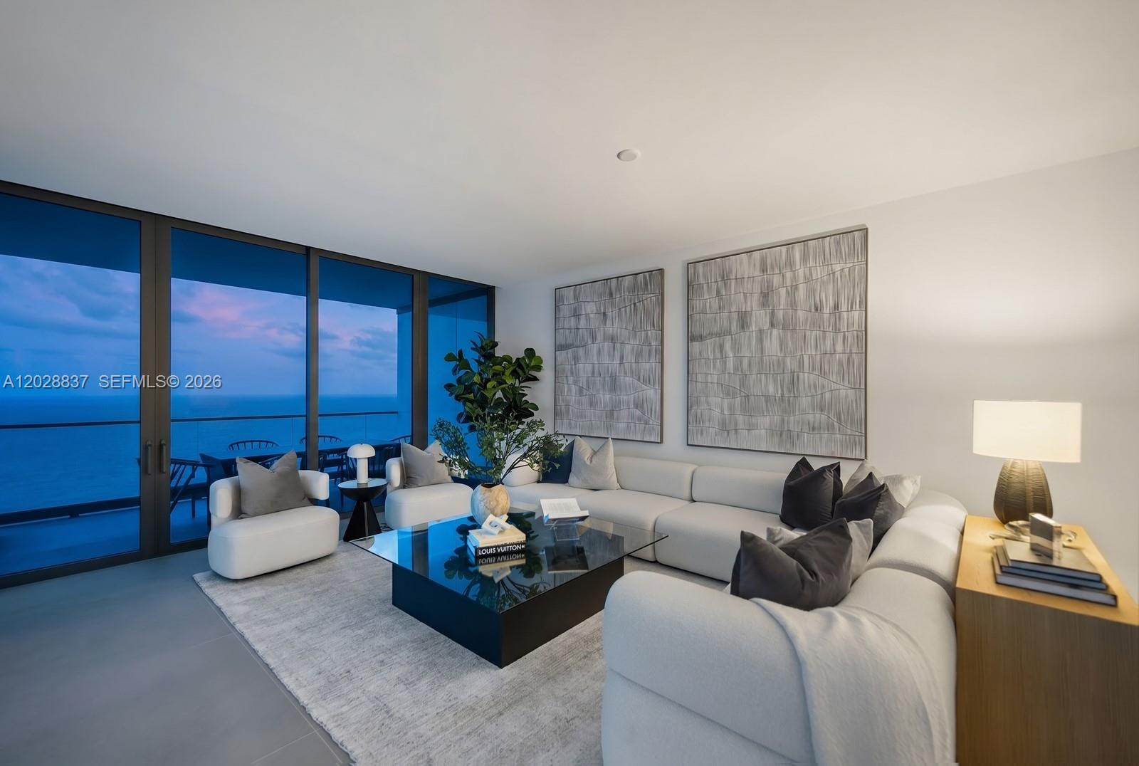 A modern living room features a white sectional sofa, glass coffee table, and ocean views — 2000 S Ocean Dr # 32A, Hallandale Beach FL 33009, HALLANDALE BEACH, FL