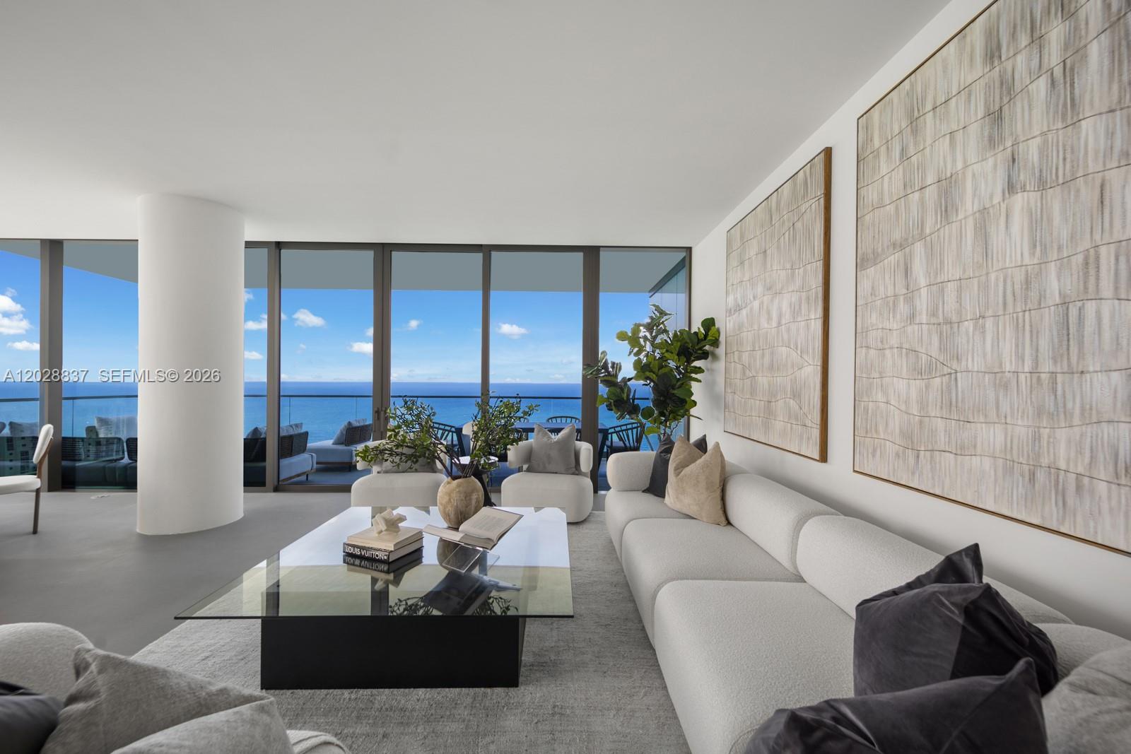 A modern living room features a white sofa, glass coffee table, and floor-to-ceiling ocean views — 2000 S Ocean Dr # 32A, Hallandale Beach FL 33009, HALLANDALE BEACH, FL